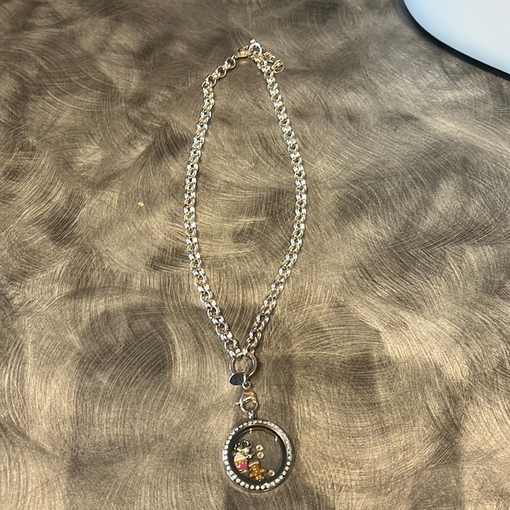 Origami owl necklace with charms. Silver in color